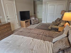 a bedroom with a large bed and a television at Unit 411B 1Bd 1Ba Efficiency Condo Condo in Birchwood