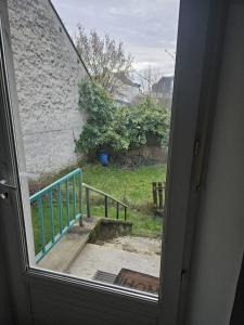an open door with a view of a stairway at F2 avec jardin in Nemours