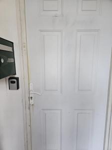 a white door with two doors on a wall at F2 avec jardin in Nemours