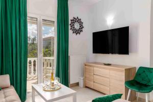 a living room with a television and green curtains at Villa Mika in Zakynthos