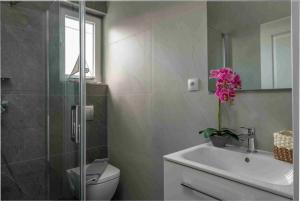 a bathroom with a sink and a toilet and a mirror at Villa Mika in Zakynthos +21 photos