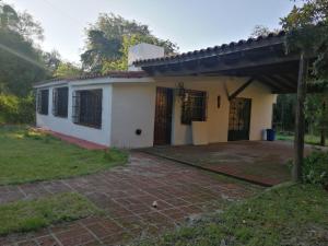 a small white house with a patio at Casa Canela in La Cumbre