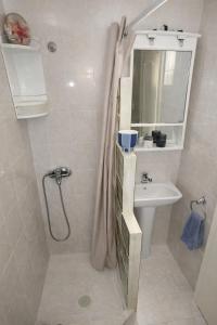 a bathroom with a shower and a sink and a toilet at Mola's Memories in Mola Kalyva +13 photos