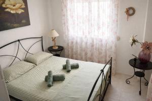 a bedroom with a bed with two cups on it at Mola's Memories in Mola Kalyva