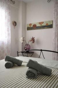 a bedroom with a bed with towels on it at Mola's Memories in Mola Kalyva