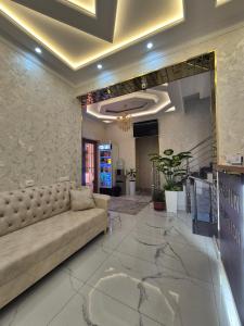 a large living room with a couch in a lobby at YASMIN in Samarkand