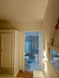 a bathroom with a toilet and a window and a door at B&B Casavecchia in Gallipoli