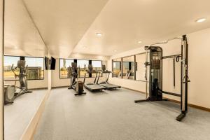 an empty gym with treadmills and elliptical machines at LivAway Suites Phoenix Tolleson in Phoenix
