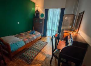 a bedroom with a bed and a desk and a chair at Retro private room in common apartment in Athens