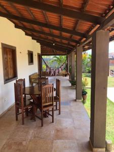 a dining room with a table and chairs on a patio at Casa dunas in Guajiru