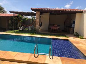 a swimming pool in front of a house at Casa dunas in Guajiru