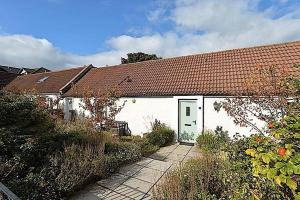 a white house with a red roof at Charming Old Cottage for Share, Cosy Double Room with 2 Single Bed in Edinburgh