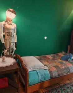 a bedroom with a bed and a mannequin next to a table at Retro private room in common apartment in Athens