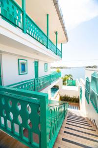 a balcony of a house with a green railing at Hotel Casa Turquesa in Flores