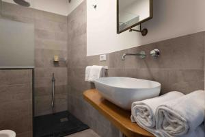 a bathroom with a white sink and a shower at EvasRooms Open space in Vernazza +7 photos