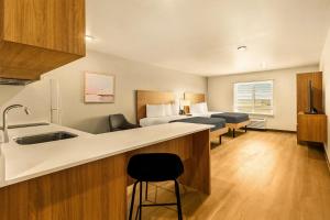 a hotel room with a kitchen and a bedroom at LivAway Suites Phoenix Tolleson in Phoenix