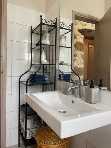 a bathroom with a white sink and a black shelf at DOLONAS Cosy House in Aliyoí +38 photos