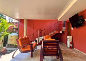 a living room with orange walls and a staircase at Villa Noelia in El Jurón