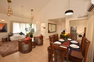 a dining room and living room with a table and chairs at Azure Luxury 3-Bedroom Penthouse Candolim, Next to Novotel and Starbucks, close to Beach - By Lembranca in Candolim