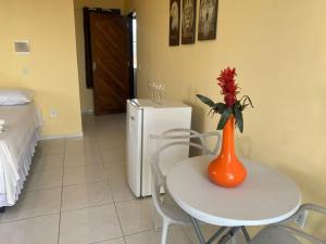 an orange vase sitting on a table in a kitchen at Suíte prime in Monte das Gameleiras