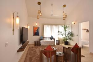 a living room with a couch and a tv at Azure Luxury 3-Bedroom Penthouse Candolim, Next to Novotel and Starbucks, close to Beach - By Lembranca in Candolim