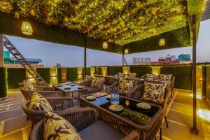 a restaurant with tables and chairs on a roof at HOTEL UPTOWN with Luxury Restaurant & Rooftop Near Connaught Place, New Delhi City Centre in New Delhi