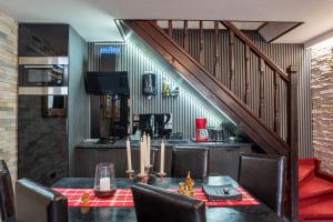 a dining room with a table and a staircase at Pension Casa Wenge - Jacuzzi Room in Sinaia