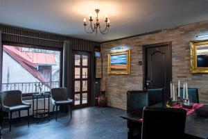 a living room with a table and chairs and a chandelier at Pension Casa Wenge - Jacuzzi Room in Sinaia