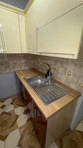 a kitchen with a sink and a counter top at Apartament 11 Słoneczna in Ełk