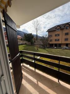 a view from the porch of a house with a fence at Le Genev Altitude - Studio Lumineux - Vue Montagne in Collonges-sous-Salève