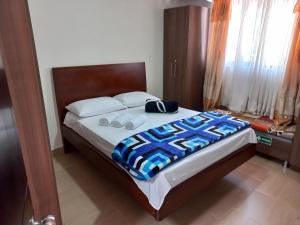 a bedroom with a bed with two slippers on it at VISTALMONTE in Salento
