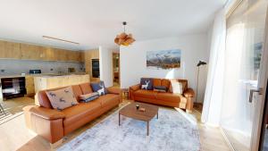 a living room with two couches and a table at Alphubel PEAK in Saas-Fee