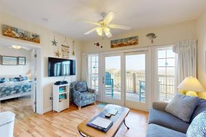 a living room with a couch and a tv at HADS814 Wahoo 814 #102DS-H in Hatteras