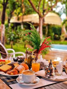 a table with breakfast foods and coffee on it at Hotel EZZAHIA by HMS in Marrakesh