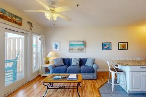 a living room with a blue couch and a table at HADS814 Wahoo 814 #102DS-H in Hatteras