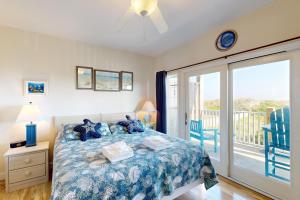 a bedroom with a bed and a balcony at HADS814 Wahoo 814 #102DS-H in Hatteras +17 photos