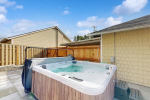 a hot tub on the back of a house at Cozy Seaside Bungalow, Brand New Hot Tub, Fast WiFi & W&D - Walk to the Beach in Seaside