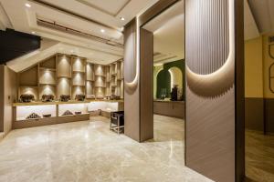 a lobby with a large glass door in a building at The Vanson Pride, Delhi Central Stay in New Delhi
