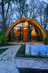 a round house with a curved roof and a patio at Cottage TKESHI in Godogani