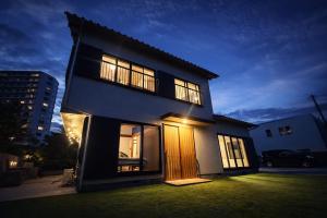 a house with its door open in a yard at Eternity Marina HOUSE ONJUKU in Onjuku