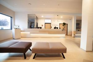 a living room with two ottomans and a couch at Best Western Hotel Tulln in Tulln