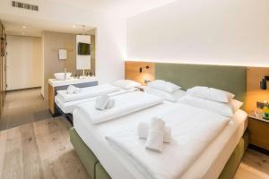 two beds with white pillows in a room at Best Western Hotel Tulln in Tulln +62 photos