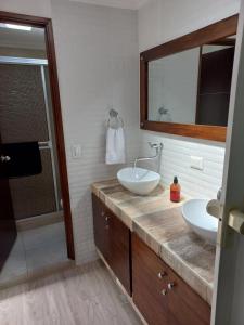 a bathroom with two sinks and a shower at VISTALMONTE in Salento +21 photos