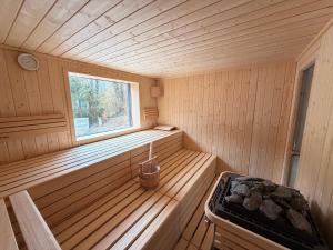 a wooden sauna with a window and a stove at Rurtal de luxe in Simmerath