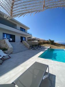 a villa with a swimming pool and a house at Villa Zina mit Infinity-Pool und Meerblick in Sitia