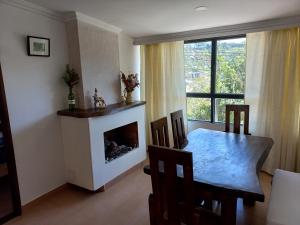 a living room with a table and a fireplace at VISTALMONTE in Salento