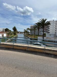 a view of a river with palm trees and buildings at Apartamento Rincón de la calma in Alcudia