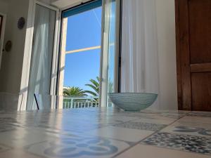 a dining room with a table and a large window at Il cuore di Moneglia - MONEGLIA APARTMENTS in Moneglia