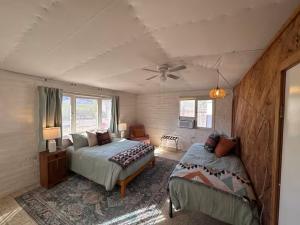 a bedroom with two beds and a ceiling fan at Tucson Mountain Guest Ranch in Tucson +73 photos