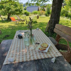 a picnic table with a plate of bread on it at River House Radolca in Radovljica